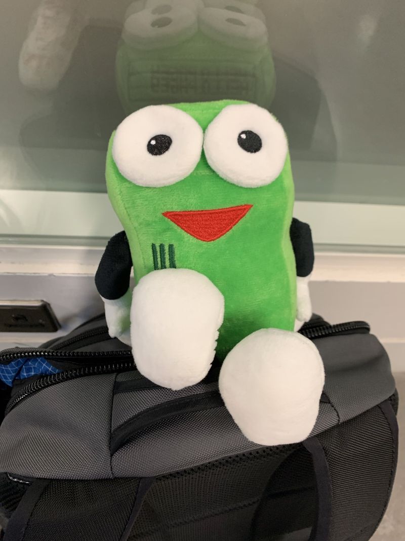 Plush Pagey, PagerDuty's mascot. A green rectangle with arms and legs.
